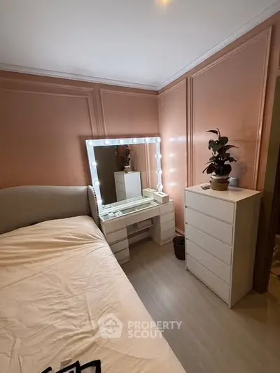 Charming bedroom with elegant vanity and soft lighting, perfect for relaxation and style.