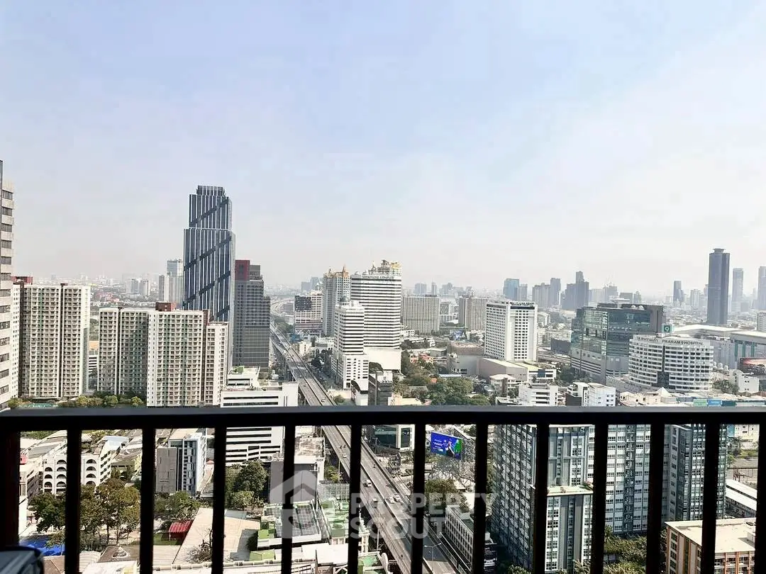 Stunning cityscape view from a high-rise balcony in a bustling urban area.