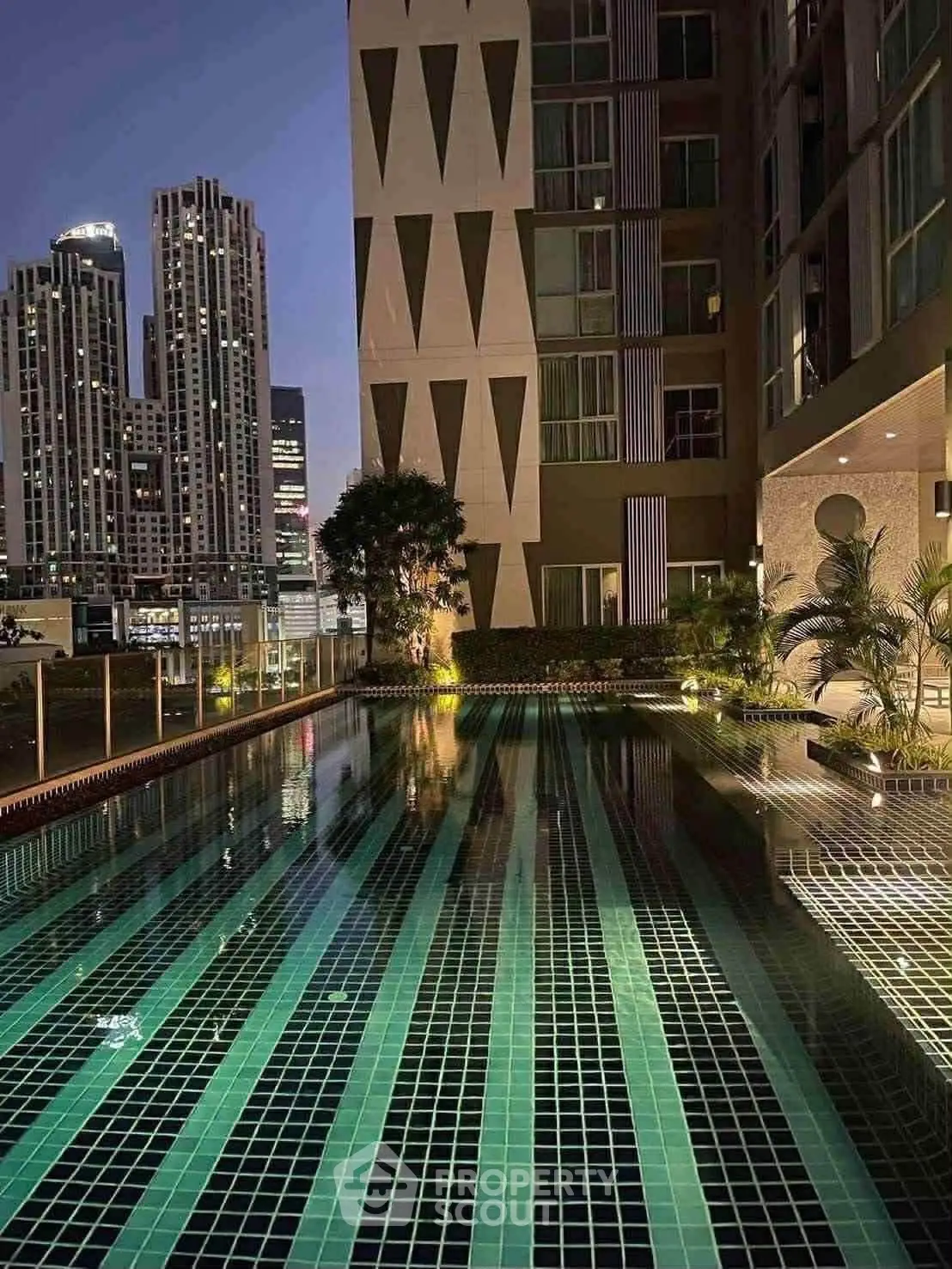 Luxurious rooftop pool with stunning city skyline views at night