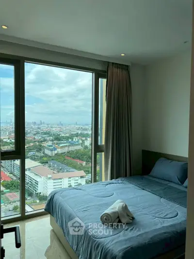 High-rise bedroom with stunning city view and modern decor