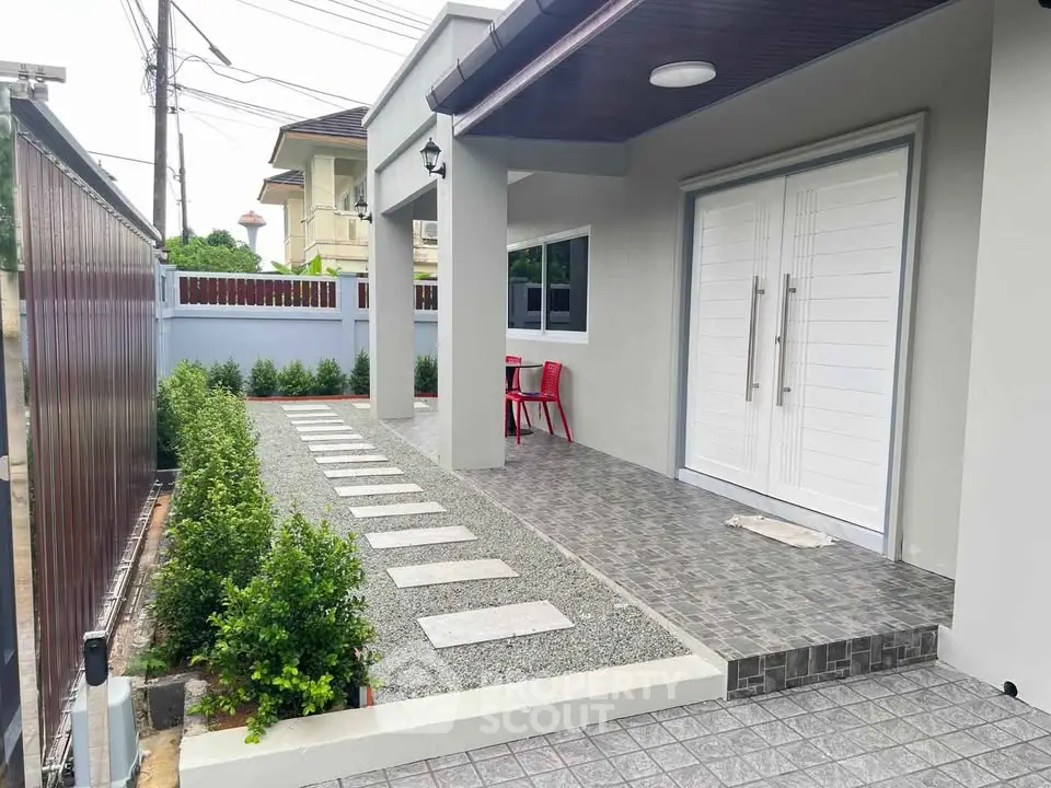 Modern home entrance with sleek design and landscaped pathway