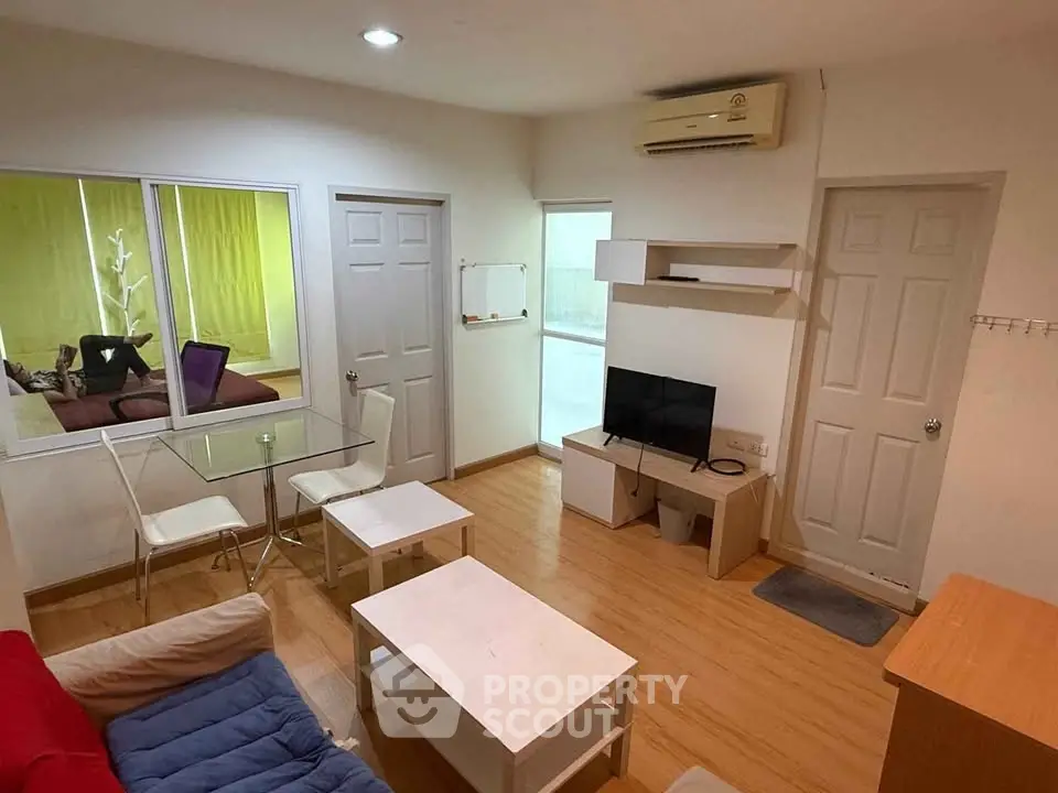 Cozy living room with modern furniture and air conditioning, perfect for relaxation and entertainment.
