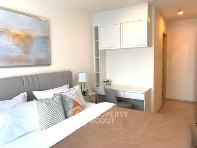Modern bedroom with stylish decor and cozy ambiance, featuring a comfortable bed and elegant artwork.