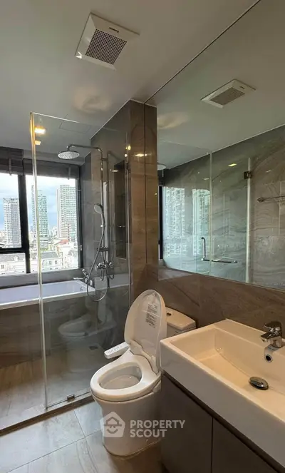 Modern bathroom with city view, featuring glass shower and sleek fixtures.