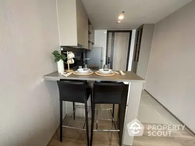 Modern kitchen with sleek breakfast bar and stylish seating in contemporary apartment