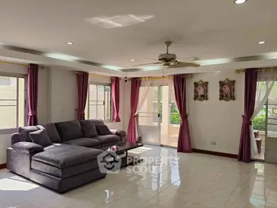 Spacious living room with elegant decor and abundant natural light