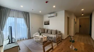 Modern living room with cozy sofa and large window offering city view