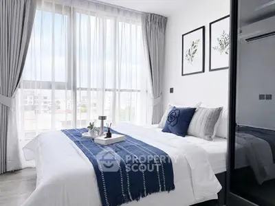 Bright and modern bedroom with large windows and stylish decor in a high-rise apartment.