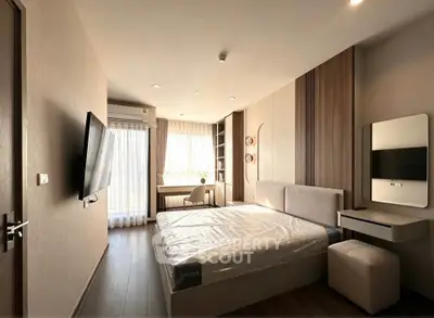 Modern bedroom with sleek design, featuring a large bed, wall-mounted TV, and ample natural light from large windows.