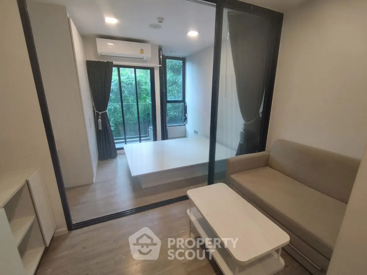 Modern living room with glass partition and cozy sofa in a stylish apartment.