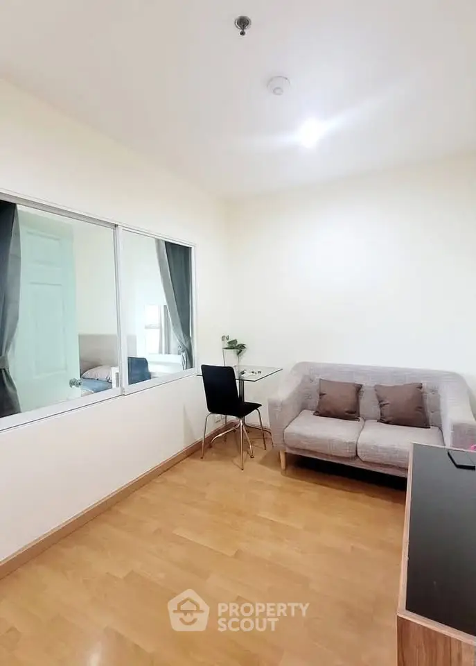 Modern living room with cozy sofa and glass partition in stylish apartment