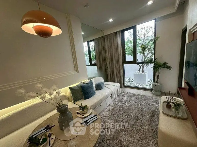 Stylish living room with modern decor, large windows, and cozy seating area.