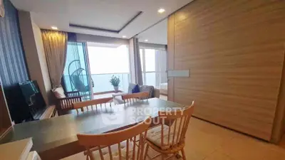 Modern living room with dining area and balcony view