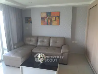 Modern living room with stylish sofa and abstract art, perfect for relaxation and entertaining.
