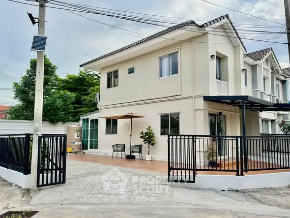 Charming two-story house with modern exterior and spacious driveway in a serene neighborhood.