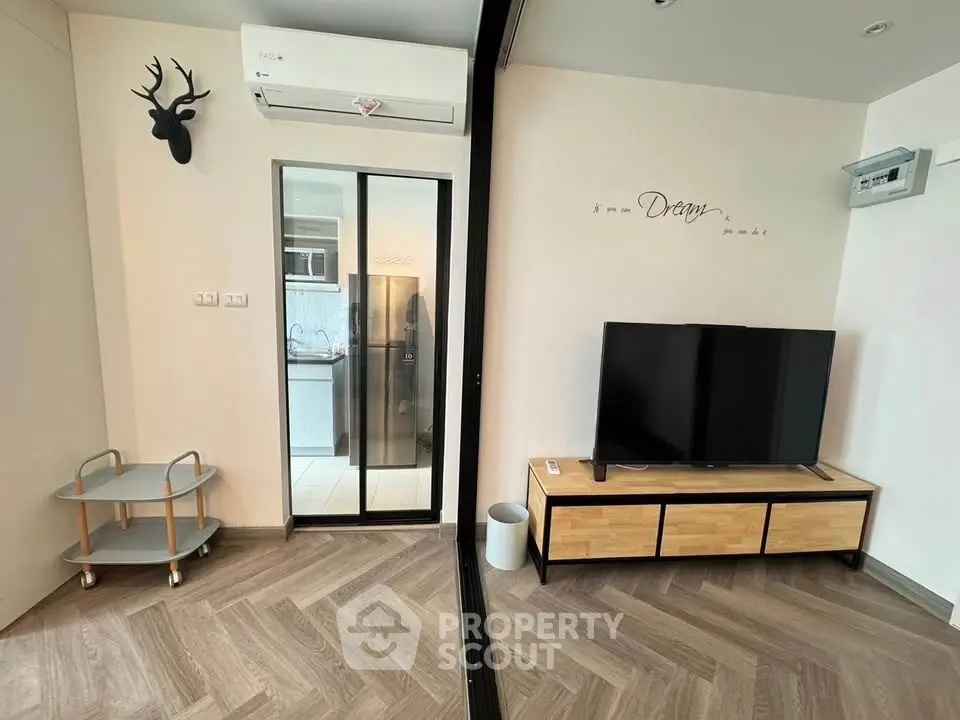Modern living room with stylish decor and sliding glass door to kitchen