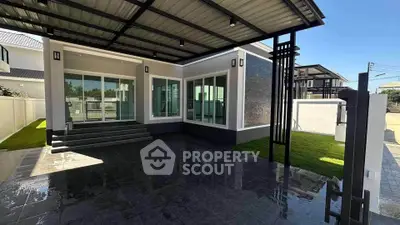 Modern house exterior with sleek design and spacious patio area