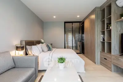 Modern studio apartment with cozy living area and stylish bedroom design.