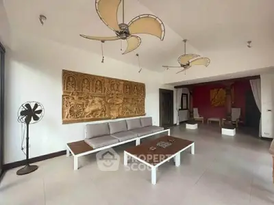 Spacious living room with unique ceiling lights and artistic wall decor