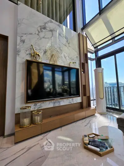 Luxurious living room with marble accents and floor-to-ceiling windows offering stunning city views.