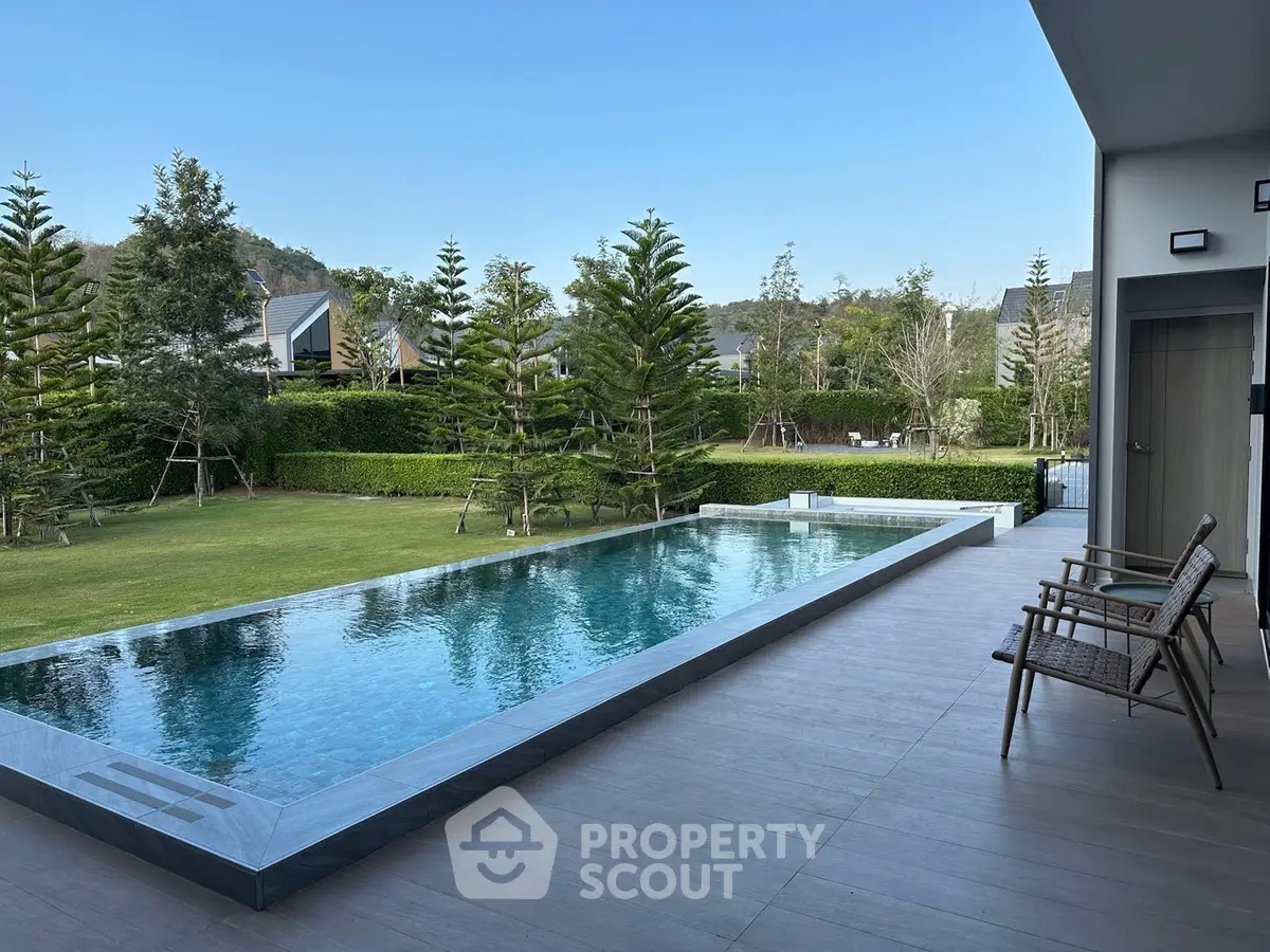 Luxurious modern home with stunning pool and lush garden view