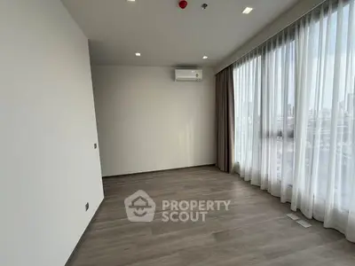 Spacious empty room with large windows and city view, perfect for customization.