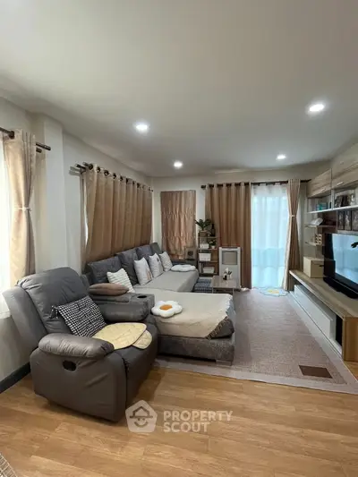 Spacious living room with cozy sectional sofa and modern entertainment center