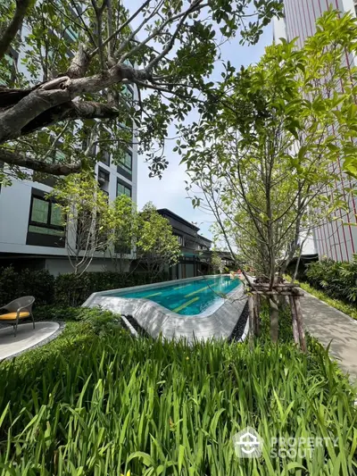 Luxurious residential pool surrounded by lush greenery and modern architecture