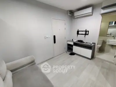 Modern minimalist living space with air conditioning and sleek furniture.