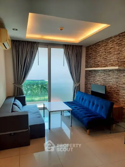 Modern living room with stylish decor and large windows offering scenic views.