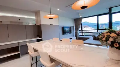 Modern open-plan living room with stylish dining area and scenic view