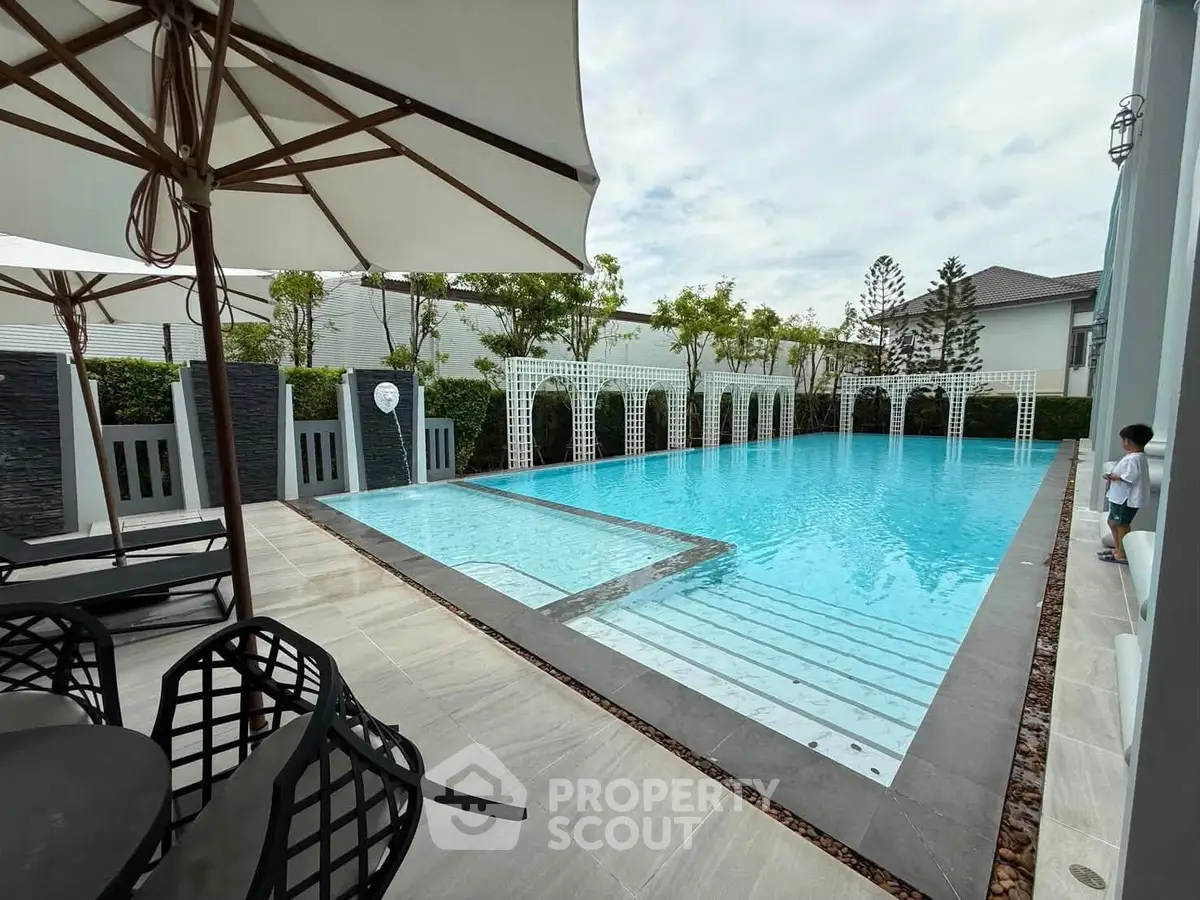 Luxurious outdoor pool area with elegant design and modern amenities, perfect for relaxation and entertainment.