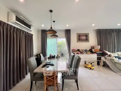 Spacious living room with modern dining area and playful decor