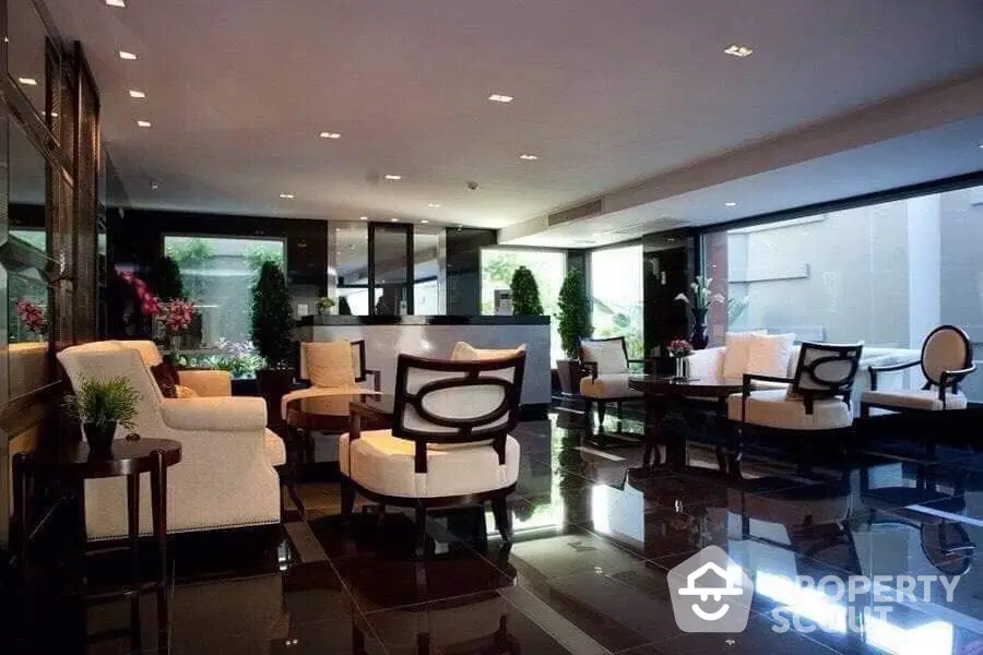 Luxurious spacious living room with polished marble floors, contemporary furniture, and floor-to-ceiling windows offering abundant natural light.