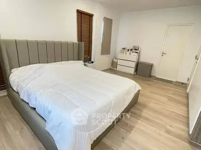 Spacious modern bedroom with elegant bed and minimalist decor