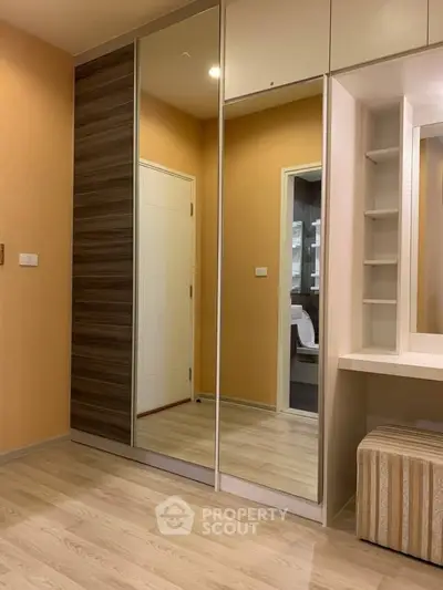 Modern bedroom with mirrored wardrobe and sleek design