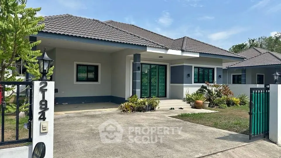 Charming single-story house with modern design and lush garden in a serene neighborhood.