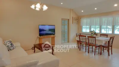 Spacious living room with elegant dining area and natural light