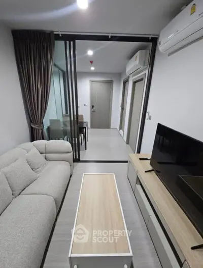 Modern living room with sleek furniture and open layout in a stylish apartment.