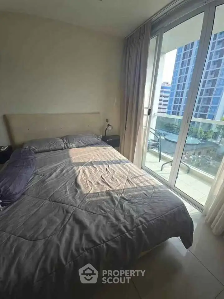 Modern bedroom with balcony view in urban high-rise apartment