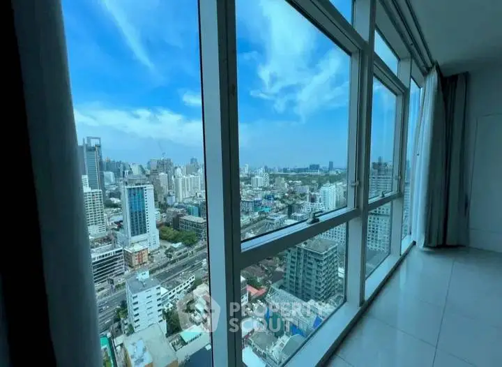Stunning high-rise city view from modern apartment window.
