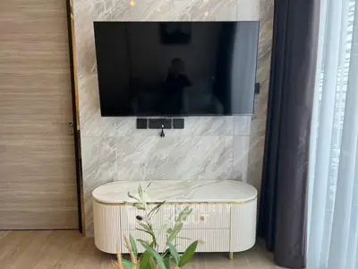 Modern living room with wall-mounted TV and stylish cabinet