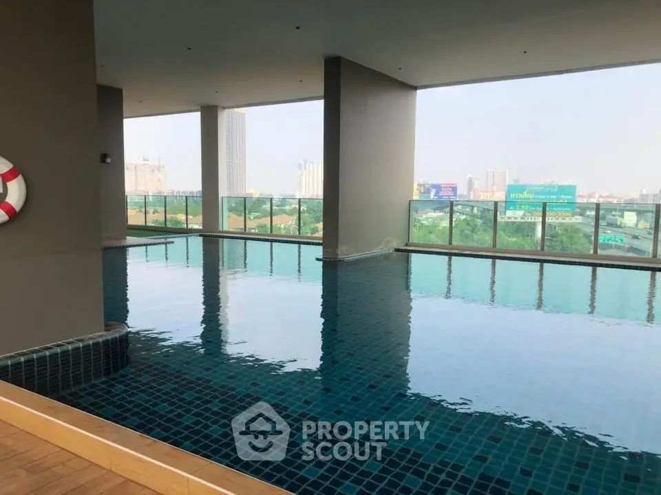 Luxurious rooftop pool with stunning city views in modern high-rise building.