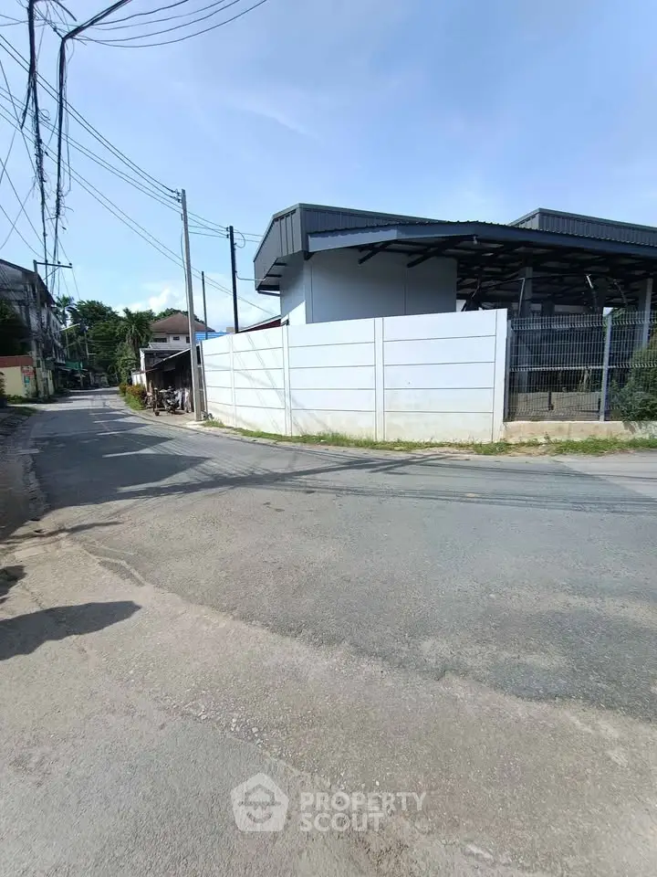 Industrial building exterior with street view and clear blue sky