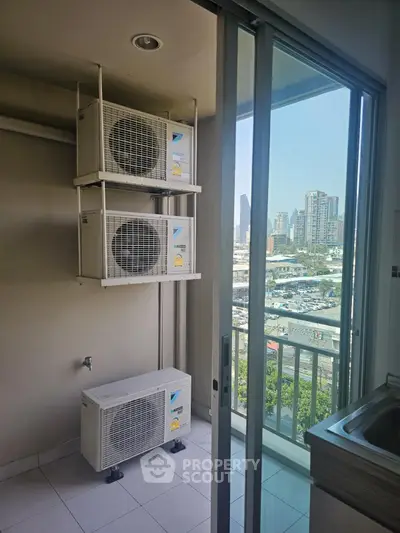 Modern apartment balcony with city view and air conditioning units