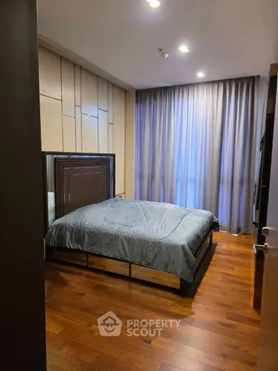 Modern bedroom with wooden flooring and stylish decor