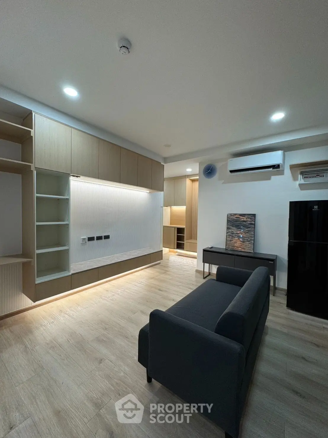 Modern living room with sleek furniture and built-in storage