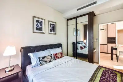 Elegant bedroom with stylish decor and mirrored wardrobe in modern apartment