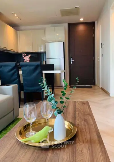 Modern living room with stylish decor and open kitchen layout in a contemporary apartment.