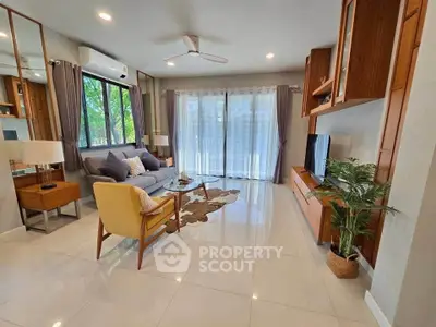 Spacious modern living room with large windows and stylish furniture